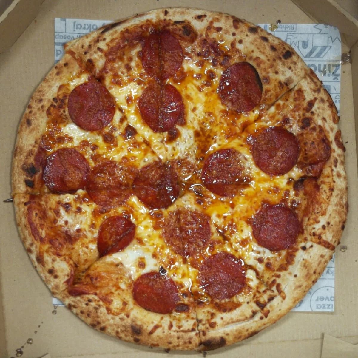 Pepperoni pizza packed without a pizza saver